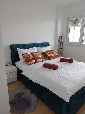 a large bed with two pillows on top of it at Apartment M & N in Banja Luka