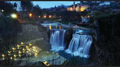 a view of a waterfall at night with lights at Paulinio in Jajce
