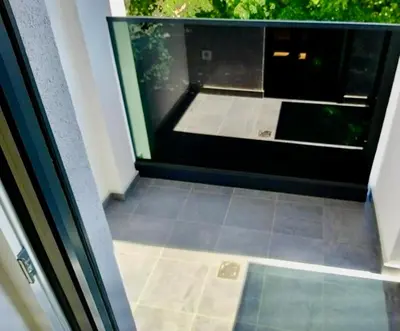 a view of a glass door with a tile floor at Apartman Nova Varos Banjaluka in Banja Luka