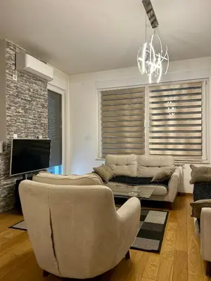 a living room with a couch and a tv at Apartman Nova Varos Banjaluka in Banja Luka