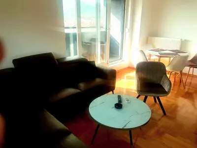 a living room with a couch and a table at Apartman Venecija in Banja Luka