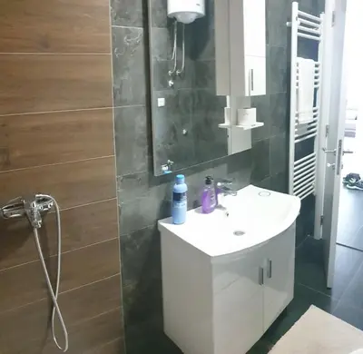 a bathroom with a white sink and a mirror at Apartman Venecija in Banja Luka