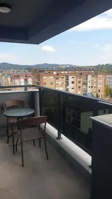 a balcony with two chairs and a table on a building at Apartman Venecija in Banja Luka