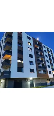 a tall building with balconies on the side of it at Apartman Venecija in Banja Luka
