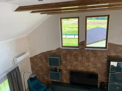 a living room with two windows and a tv at Family resort TRAPISTI in Banja Luka