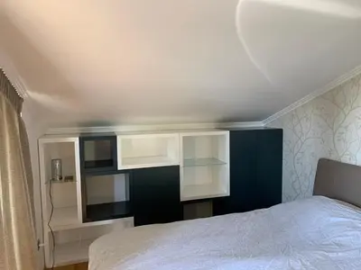 a bedroom with a bed and some white cabinets at Family resort TRAPISTI in Banja Luka