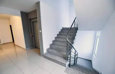 a staircase in a building with a metal railing at Apartman Garden in Banja Luka