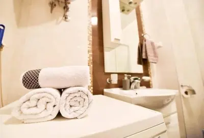 a bathroom with towels on top of a counter at Apartman Garden in Banja Luka