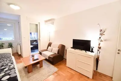 a living room with a couch and a tv at Apartman Garden in Banja Luka