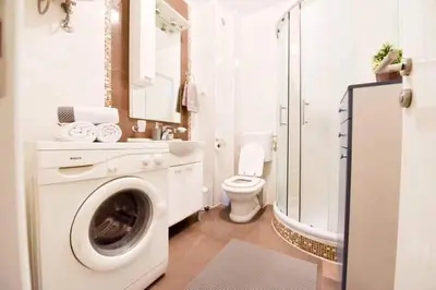 a bathroom with a washing machine and a toilet at Apartman Garden in Banja Luka