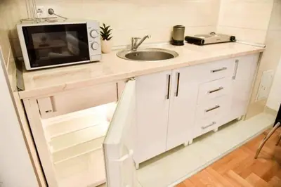 a small kitchen with a sink and a microwave at Apartman Garden in Banja Luka
