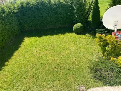 a small yard with a green field of grass at Villa Nana in Kulen Vakuf