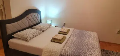 a bedroom with a bed with two towels on it at Apartman Stepa in Banja Luka