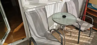 a glass table and a chair in a tiny house at Apartman Stepa in Banja Luka
