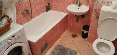 a bathroom with a toilet and a sink and a washing machine at Apartman Stepa in Banja Luka