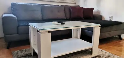 a blue couch with a table in a living room at Apartman Stepa in Banja Luka