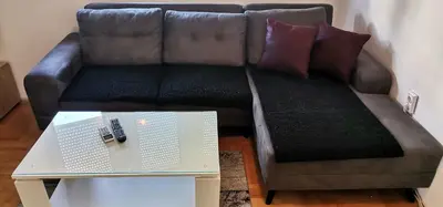 a couch with two pillows and a coffee table at Apartman Stepa in Banja Luka