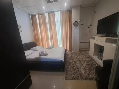 a hotel room with a bed and a large window at Hotel Fortuna in Banja Luka