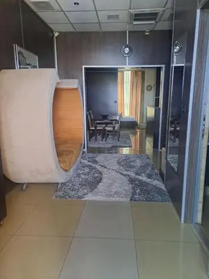 a living room with a table and a large rug at Hotel Fortuna in Banja Luka
