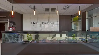 a hotel room with a fish tank in a lobby at Hotel Fortuna in Banja Luka