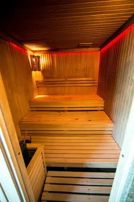 an empty wooden sauna with a red light in it at Hotel Fortuna in Banja Luka