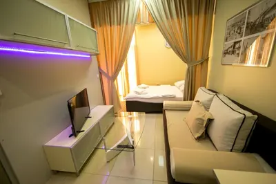 a small living room with a couch and a television at Hotel Fortuna in Banja Luka