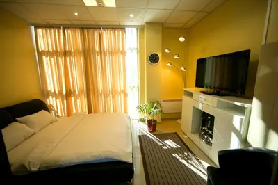 a bedroom with a bed and a flat screen tv at Hotel Fortuna in Banja Luka