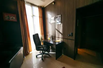 a room with a desk and a chair and a window at Hotel Fortuna in Banja Luka