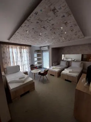a large room with two beds and a table at Motel Bajra in Travnik