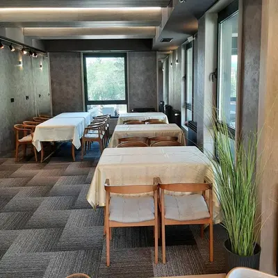 a row of tables in a room with tables and chairs at Motel Bajra in Travnik