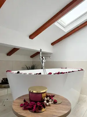 a bathtub in a kitchen with a bowl on a table at Apartmani Gandi in Bihać