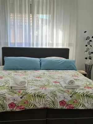a bedroom with a bed with towels on it at Apartmani Gandi in Bihać