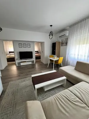 a living room with a couch and a table at Apartmani Gandi in Bihać