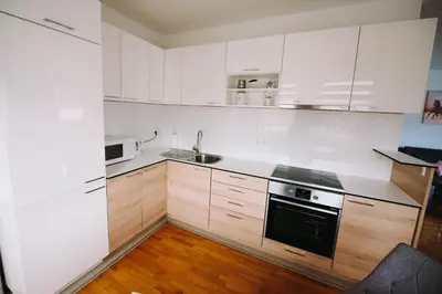 a kitchen with white cabinets and a sink and a stove at Apartman Oaza in Banja Luka