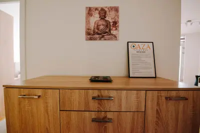 a wooden cabinet in a room with a picture on the wall at Apartman Oaza in Banja Luka