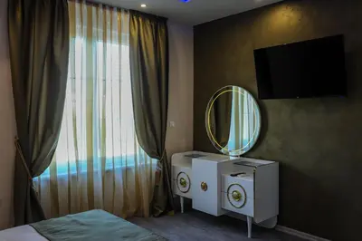 a hotel room with a mirror and a bed and a mirror at Apartmani President V in Banja Luka
