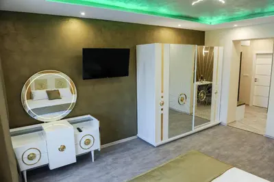 a room with a mirror and a sink and a mirror at Apartmani President V in Banja Luka