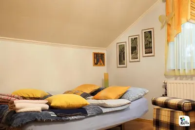 a bed with pillows on it in a room at Holiday home Veky in Kupres