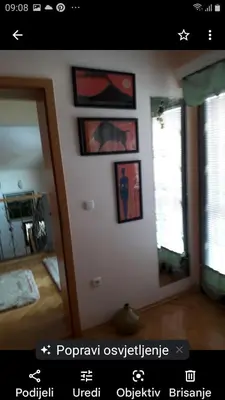 a room with pictures on the wall and a mirror at Holiday home Veky in Kupres