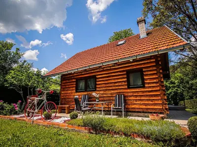 a log cabin with a bike parked in front of it at Home Eden Dobrenica in Bihać