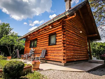 a log cabin with a patio and a table at Home Eden Dobrenica in Bihać