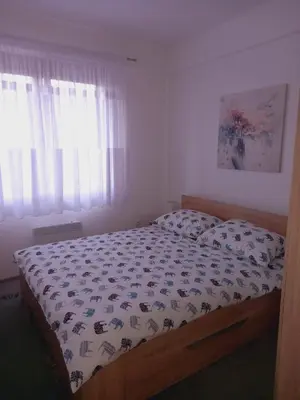 a bedroom with a bed with a comforter on it at Apartman Tea in Kupres