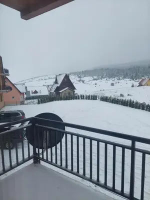 a view from the balcony of a snow covered yard at Apartman Tea in Kupres
