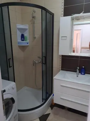 a bathroom with a shower and a toilet and a sink at Apartman Tea in Kupres