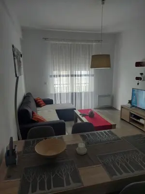a living room with a couch and a table at Apartman Tea in Kupres