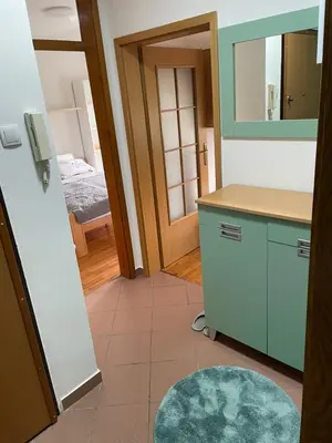 a kitchen with a sink and a mirror and a door at Lara in Banja Luka