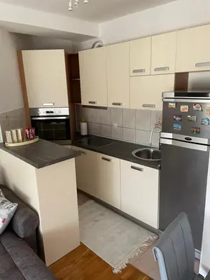 a kitchen with white cabinets and a counter top at Lara in Banja Luka