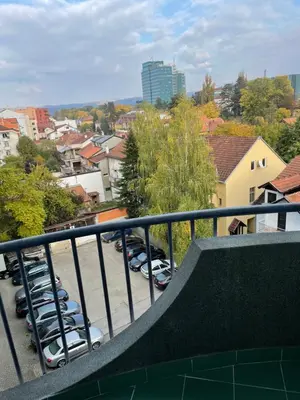 a balcony with cars parked in a parking lot at Lara in Banja Luka