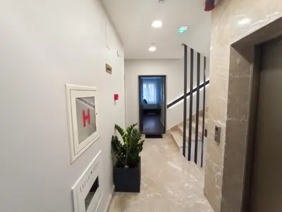 a hallway with a door and a potted plant at Premium Apartmani Banja Luka in Banja Luka