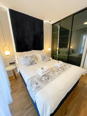 a bedroom with a large bed with two towels on it at Premium Apartmani Banja Luka in Banja Luka